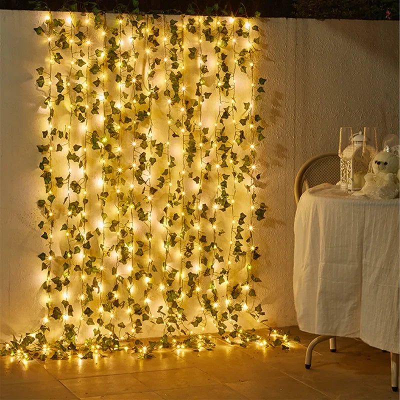 Warm-lit hanging ivy string lights cascading gracefully against a neutral wall, combining lush green leaves with soft golden illumination for a serene and natural decorative ambiance, ThuisGemak.