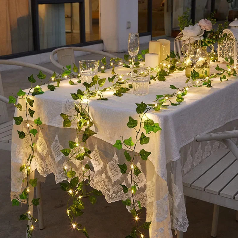 Elegant ivy string lights cascading over a lace-covered table, creating a warm and romantic glow for refined evening gatherings — ThuisGemak.