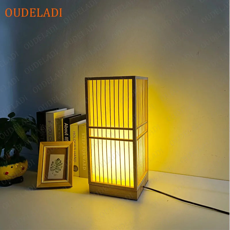 OUDELADI-japanese-table-lamp-Warm-bedside-lamp-Japaneseon-a table-with-book-behind - ThuisGemak