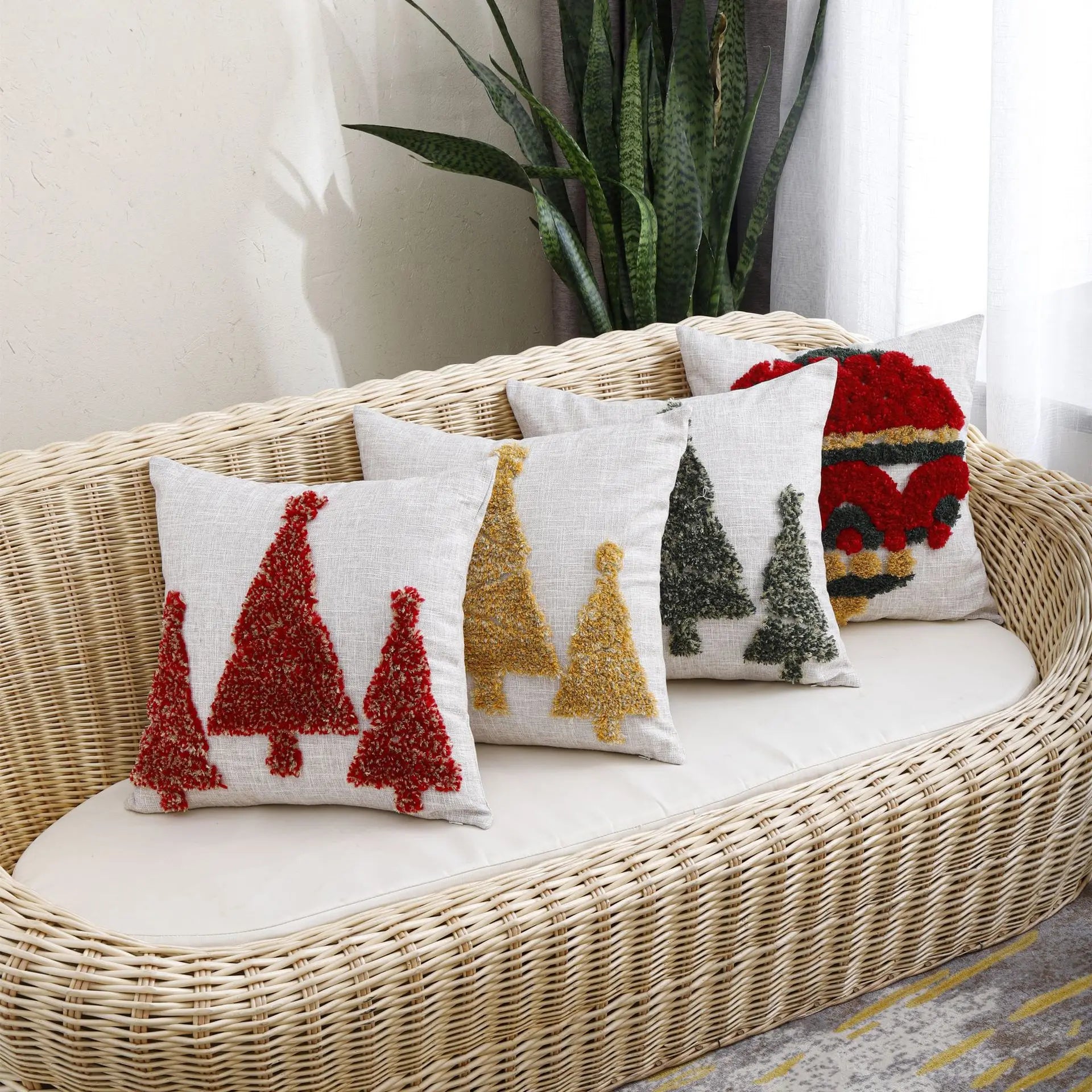 Thuisgemak Christmas cushions with red, gold, and green tufted tree designs arranged on a rattan sofa in a bright UK living room, adding cosy festive charm.