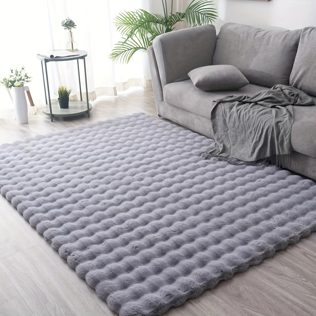 Soft grey textured rug with bubble pattern in a modern living room with grey sofa and natural light, ThuisGemak.