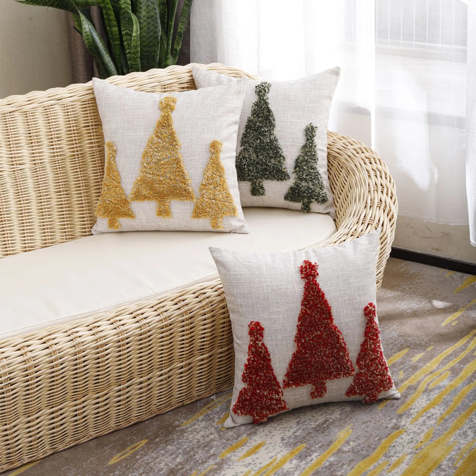 Festive Tree Cushion on a rattan sofa in a bright UK living room, adding warm Christmas charm.