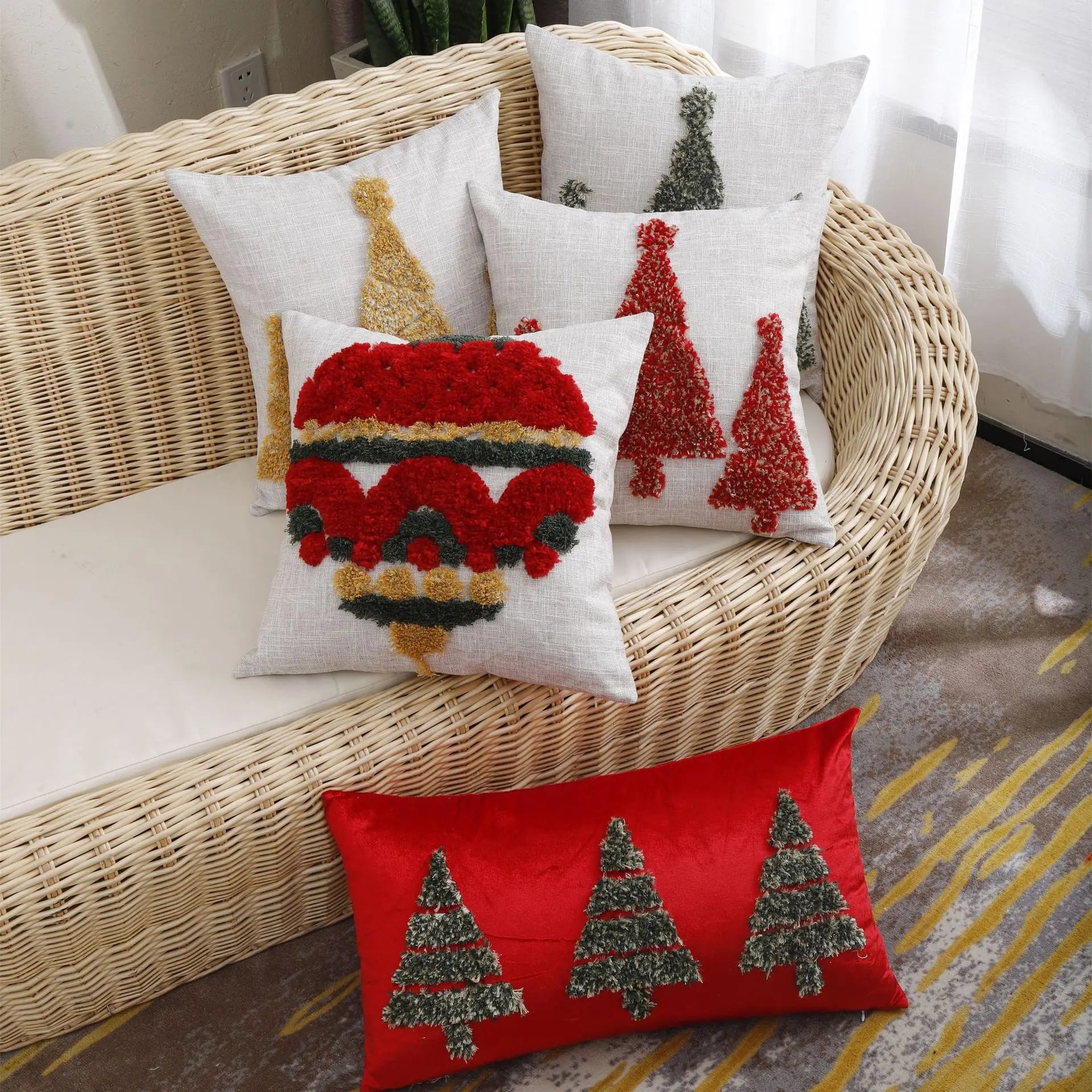 A set of Thuisgemak Christmas cushions with tufted tree and bauble designs on a rattan sofa in a cosy UK living room, blending festive warmth with modern elegance.
