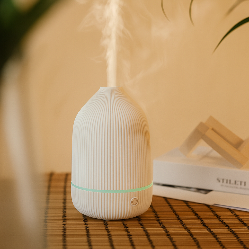 Minimalist ribbed ceramic aroma diffuser emitting gentle vapor on a bamboo mat in a warm living room, ThuisGemak.
