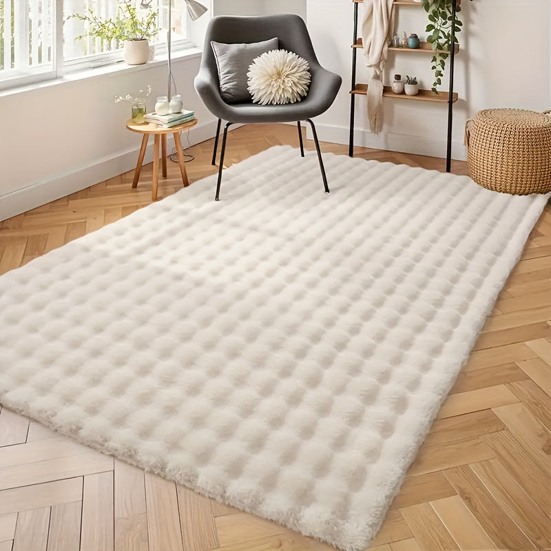 Soft cream textured rug with bubble design in a bright modern living room with wooden floor and minimalist decor, ThuisGemak.
