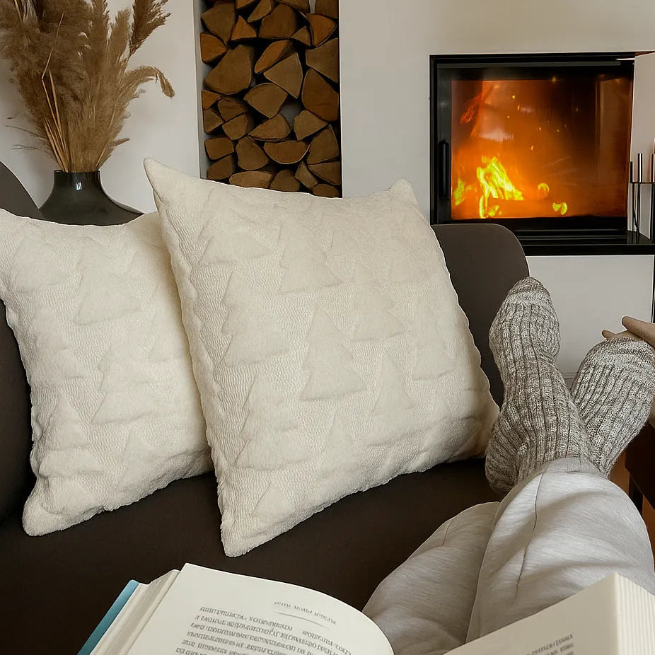 woman reading a bokk with christmas cushions